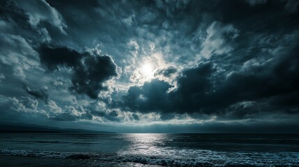 Fototapeta premium Dramatic and Moody Seascape with Sun Breaking Through Dark Storm Clouds Over the Ocean