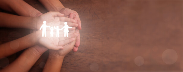 Hands holding a glowing family icon, symbolizing family mental health, home security, adoption and foster care, homeless charity support, homeschooling, and household budgeting planning