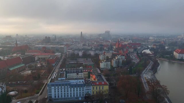 Drone panorama of Wroclaw, view of Old Town, Oder River, churches, urban buildings and winter fog covering the city