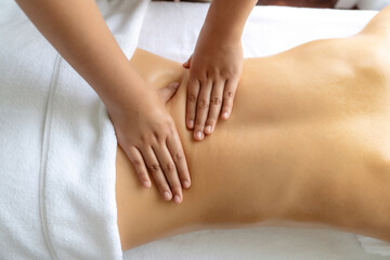 Closeup woman customer enjoying relaxing anti-stress spa massage and pampering with beauty skin recreation leisure in day light ambient salon spa at luxury resort or hotel. Quiescent