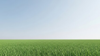 Fototapeta premium Vast green field under clear blue sky with abundant grass
