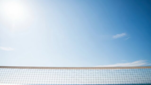 Beach volleyball net under clear blue sky on a sunny day