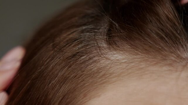 Gray roots exposed,aging hair concept.
