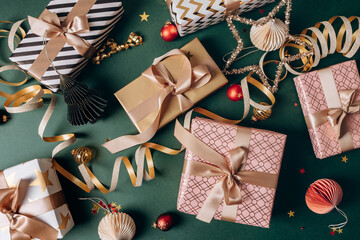 Festive Christmas new year 2026  background with  elegant wrapped gifts and golden decorations on a green background, joyful atmosphere for special occasions
