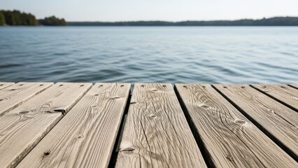 Serene lake with wooden dock under clear sky