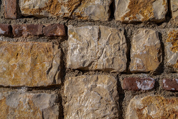 A wall built with natural stones. Stone wall