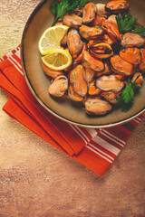 mussels no shell, boiled, mussels, peeled, in a bowl, with lemon and parsley, Chilean mussels, top view, no people,