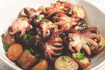 baby grilled octopus with golden baked potatoes and fresh herbs, Maltese cuisine, homemade, no people,