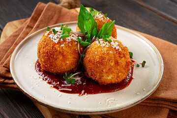 Crispy Arancini appetizer, with parmesan cheese and microgreens, plate, tomato sauce, homemade, no people,