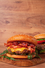 burger with beef and bacon, with arugula and caramelized onions, pickles, sauce, homemade, no people,