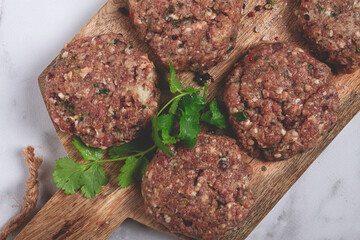 raw cutlets, minced meat, on a chopping board, homemade, top view, no people,