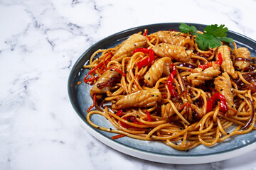 udon noodles, with squid and vegetables, on a marble table, homemade, no people,