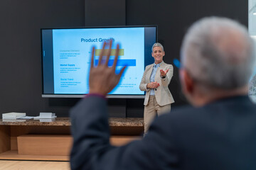 Audience member asking question during business presentation