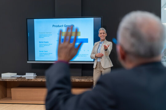 Audience member asking question during business presentation
