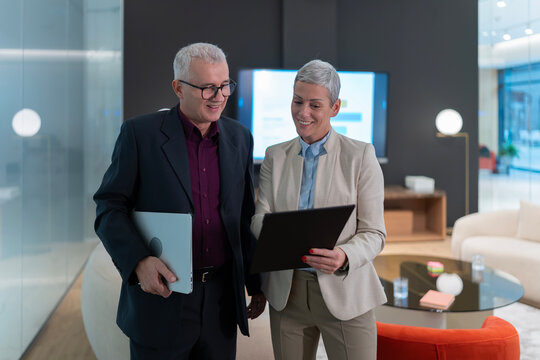 Business colleagues collaborating on project discussing digital data