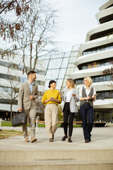 Business professionals walking together in a modern city setting during daylight