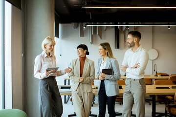 Business team discusses project ideas in modern office space during daytime meeting