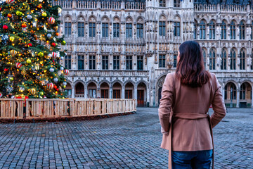 A tourist woman looks at the decorated Grande Place in Brussels, Belgium, for Christmas time