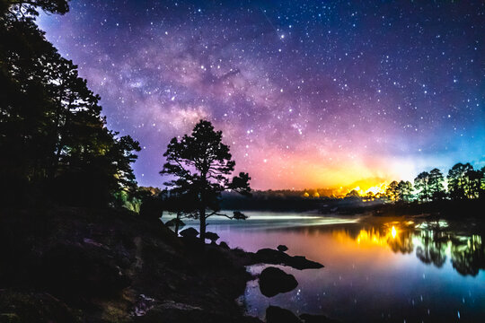 Milky way over lake arareco in creel chihuahua in winter, lake with snow at night