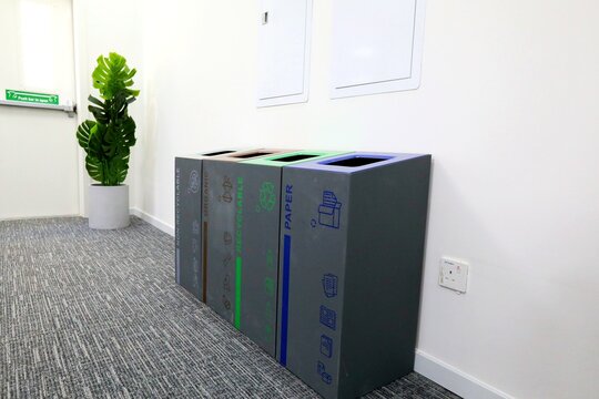 Worker installing scaffolding on building, showcasing the teamwork and safety equipment required for scaffold setup on construction site, focusing on safety harnesses and work platforms.