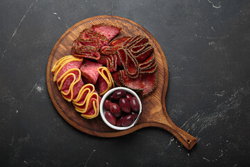 Charcuterie platter meat sliced salami pepperoni olives snack appetizer wooden board antipasto