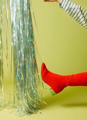 shimmering silver metallic fringe falling down, red stiletto heel on yellow surface, glossy reflections, fashion glamour style, dynamic vertical texture