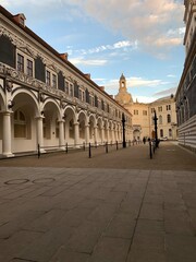 Fototapeta premium Historic European courtyard with classical arches and long shaded walkway
