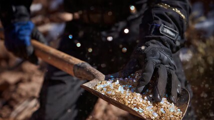 290Macro shot of glowing mineral dust and chunks, gloves and shovel foregrounded, subtle light highlights textures and critical resource significance