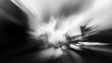 Intense black and white motion blur on a city street, depicting fast cars and buildings, capturing urban speed and abstract dynamism. © jayantha