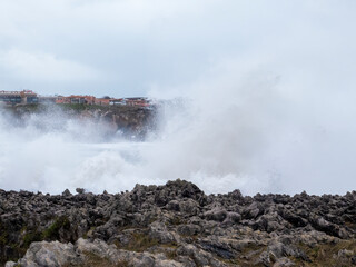 Powerful ocean waves crashing against the rocky coast of asturias