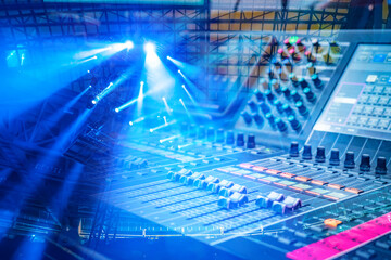 Naklejka premium Stage audio engineering involves operating a digital mixing console to control sound levels and effects during live events enhanced by professional lighting systems.