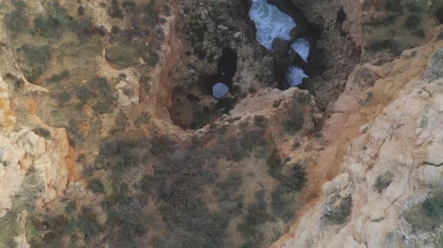 Aerial View of Rocky Cliffs with Sea Arches and Waves