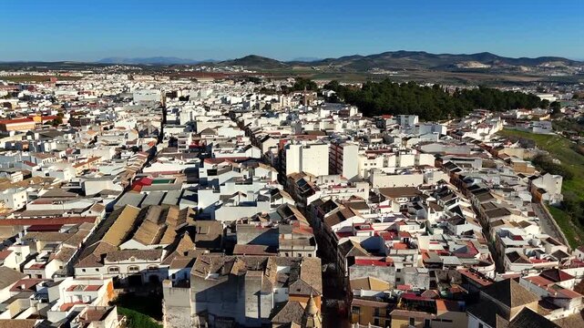 Puente Genil Andalusia Spain with white houses tiled roofs and mountains on horizon typical southern Spanish townscape