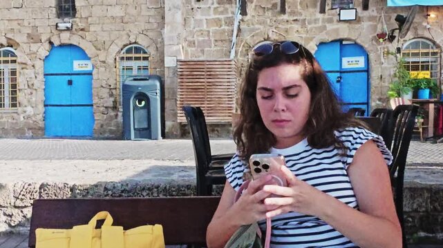 Young Tourist Woman Using Smartphone In Old Jaffa Port Israel