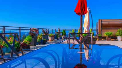 red umbrella reflected in glass patio table - summer.