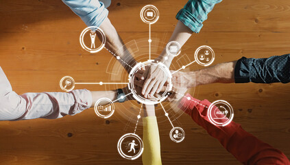 A diverse group of people joining hands in a collaborative gesture, surrounded by technology icons...