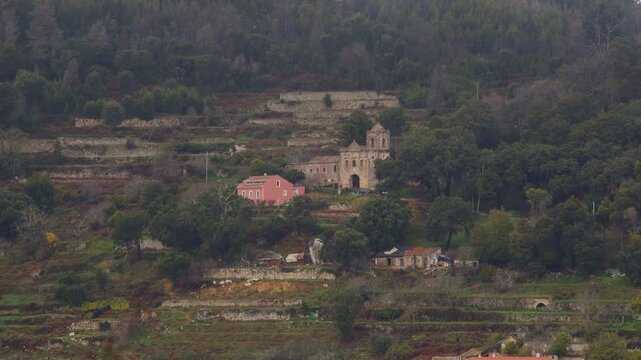 Idyllic Mountainous Countryside with an Old Church Amidst Lush Greenery in Algarve, Portugal