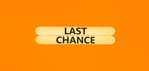 Last chance symbol. Concept word Last chance on beautiful wooden sticks. Beautiful orange paper background. Business last chance concept. Copy space.