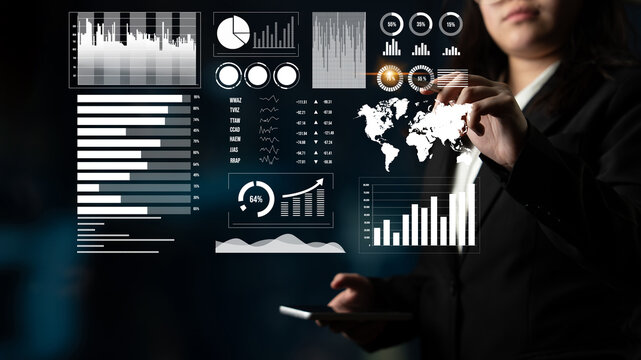 A businesswoman interacts with a digital interface showcasing data visualizations like graphs and charts, representing modern data analysis in a professional environment. Impute - Powered by Adobe