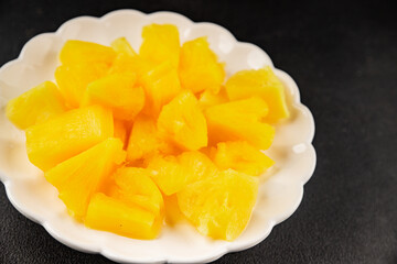 Pineapple canned chunks sweet fruit dessert tasty snack fresh delicious gourmet food background on the table rustic top view copy space keto and paleo diet vegetarian and vegan food