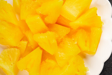 Pineapple canned chunks sweet fruit dessert tasty snack fresh delicious gourmet food background on the table rustic top view copy space keto and paleo diet vegetarian and vegan food