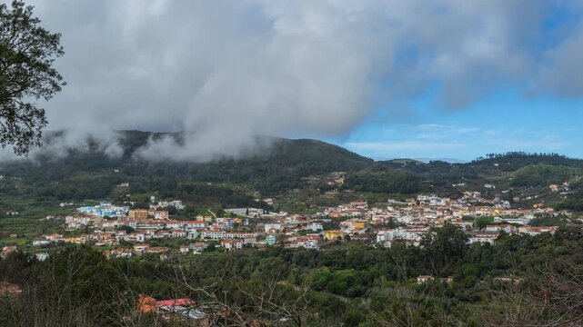 Scenic timelapse of small Portugese town of Monchique surrounded by lush green hills and cloudy sky