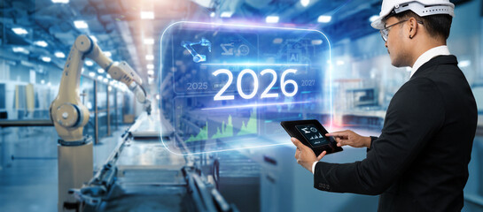 2026 years of robot automation assistant technology , industry 4.0 , artificial intelligence trend concept.Business man using digital tablet on blurred industry background