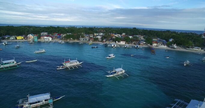 Logon Beach and Boats in Malapascua Island Seashore in Cebu, Philippines. Sulu Sea, Boats and Beautiful Seascape in Background. Drone 4k