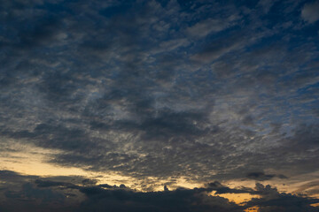 Sunset sky background with bright orange clouds.