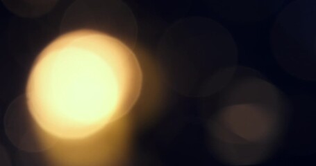 Slow motion of blurred golden light creating a warm and dreamy bokeh effect at 1000 fps, ideal as a festive or atmospheric background. - Powered by Adobe