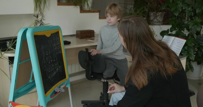 Male Teacher Gives Music Lesson for a Child. Man is Teaching Kid to Play Musical Instrument. 4K 10-bit