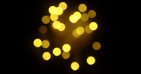 Defocused Golden Light Circles on Black Background