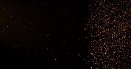 Abstract particles of gold dust float in the air