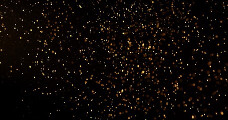 Abstract particles of gold dust float in the air